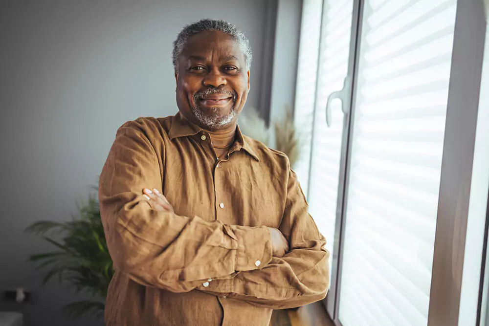 A man crosses his arms and smiles for the camera. The Birmingham Social Security Disability lawyer at Clarkson Pennington Law can help you at every stage in the process of getting disability benefits.